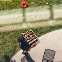 Birds Eye view of GVSU Alumna carrying box inside dorm